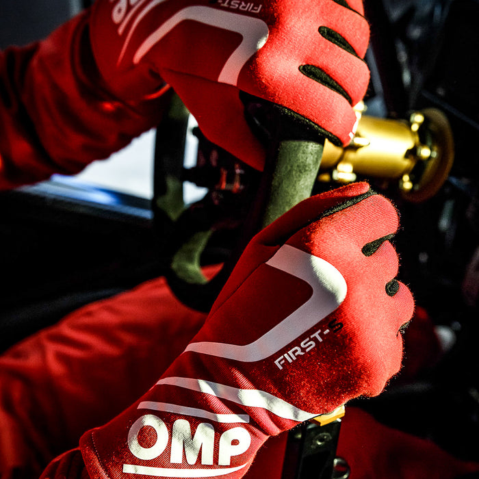 Driver Holding the Steering Wheel With OMP Racing Gloves - Fast Racer